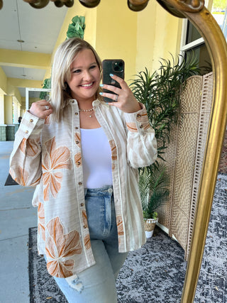 Cream and orange floral button-down shirt with striped sleeves over lavender tank top.
