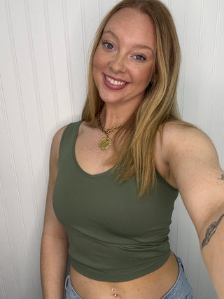 Olive green seamless racerback tank top with ribbed texture and scoop neckline.
