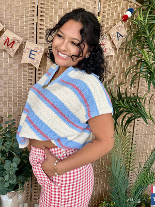 Periwinkle blue striped short-sleeve sweater with cream and red diagonal stripes.
