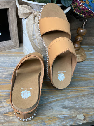 Tan leather wedge sandals with open toe, white stitching detail, and embroidered floral insole.
