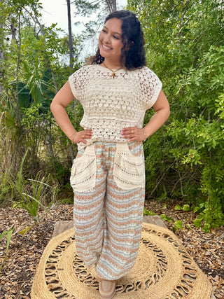 Cream crochet short-sleeve top with open knit pattern and geometric trim detail.
