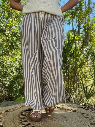 Blue and cream striped linen jogger pants with drawstring waist and relaxed fit.
