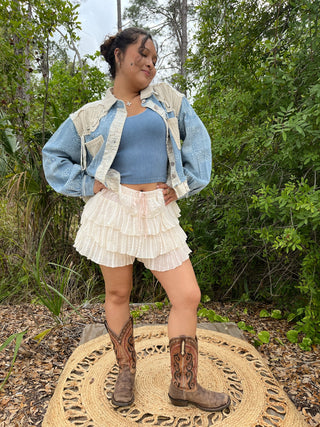 Ivory lace tier ruffle shorts with pleated layers and elastic waistband.

