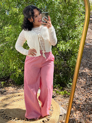 Red striped wide leg pants with elastic waist and drawstring detail.

