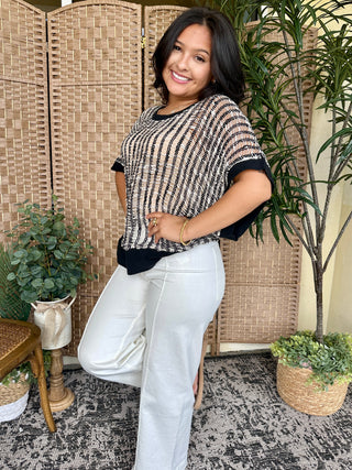 Black and white striped short-sleeve sweater with ladderback texture detail and black ribbed trim.

