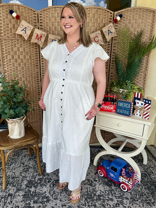 White short-sleeve button-front midi dress with textured fabric and lace accents.
