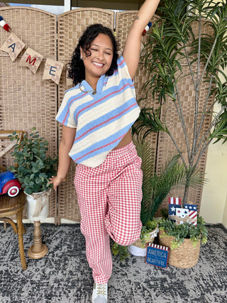 Periwinkle blue striped short-sleeve sweater top with cream and red diagonal stripes.
