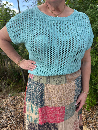 Seafoam crochet short-sleeve top with openwork knit pattern and crew neckline.
