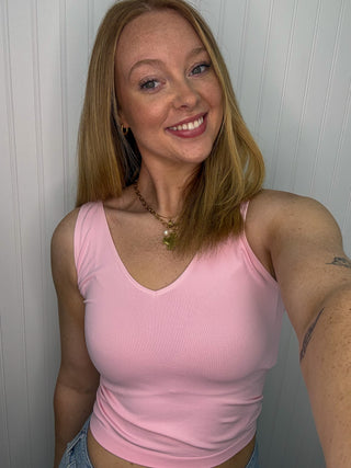 Pink buttery soft reversible seamless tank with v-neckline on model.

