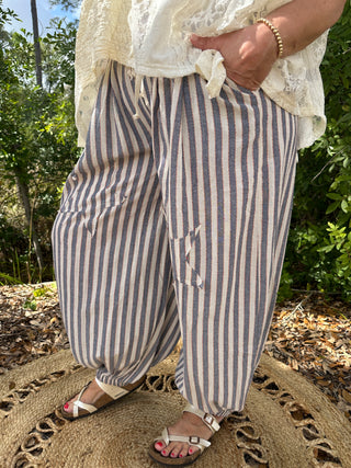 Blue and cream vertical striped jogger pants with relaxed fit and tapered ankles.
