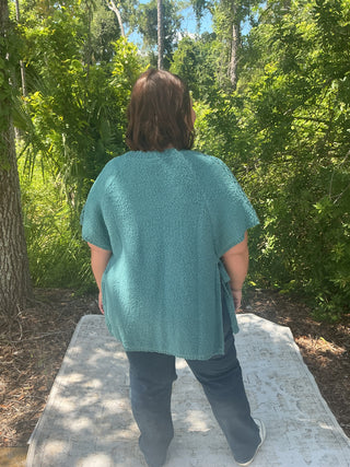 Light gray short sleeve poncho sweater with crochet accents and side ties