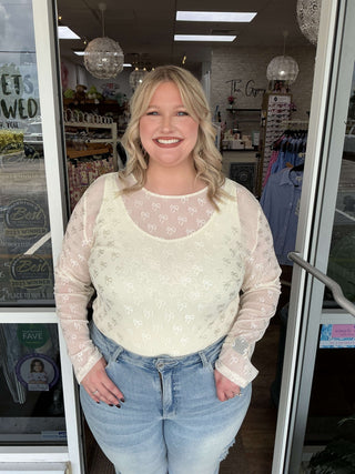 Cream Bows Long Sleeve Layer Top features a soft cream color and delicate bow accents on sleeves for a chic layered look.