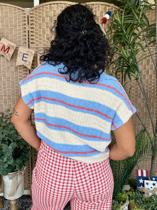 Periwinkle blue, cream, and red striped short-sleeve knit sweater.
