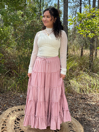 Ivory mesh long-sleeve top with ditzy floral pattern and high neckline, styled with pink gingham tiered maxi skirt.
