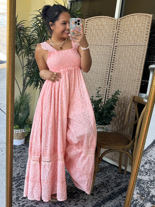 Pink eyelet empire waist maxi dress with lace-trimmed cap sleeves and flowing skirt.
