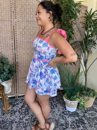 White and blue sardine print short romper with hot pink trim and ruffled shoulders.
