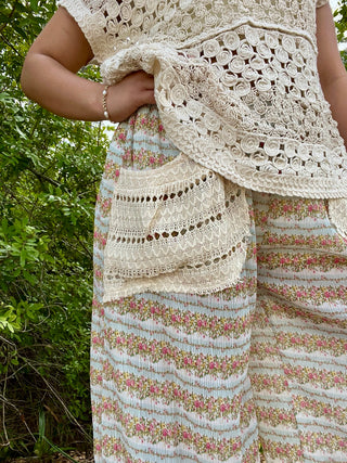 Ribbed floral pants in aqua with pink flowers, styled with cream crochet lace trim details.

