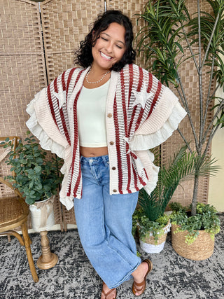 Cream and burgundy striped knit cardigan with ruffled collar and button front.

