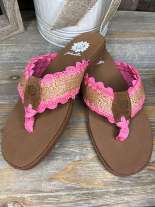 Brown thong sandals with pink and tan ruffled trim and pom-pom details.
