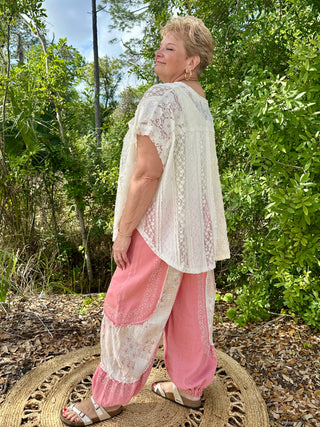 Ivory lace handkerchief top with short sleeves and sheer geometric pattern detail.

