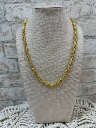 Gold twisted braided chain necklace displayed on cream fabric bust form.
