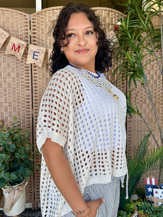 White knit dolman top with eyelet pattern and striped hem detail.
