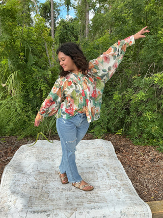 Light yellow button-down blouse with a sunflower print and short sleeves