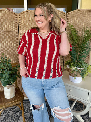 Red and white striped crochet pointelle short-sleeve top with V-neckline.
