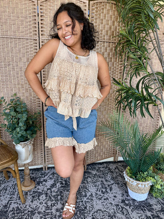 Cream lace ruffled tank top with denim shorts featuring lace trim hem.
