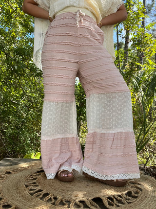 Pink and white tiered pants with ruffled lace details and cream floral lace panels.
