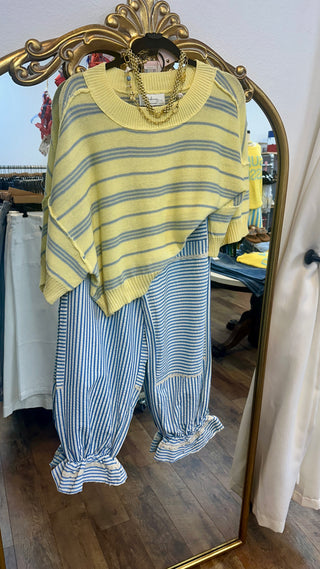 Yellow and blue striped knit sweater top with asymmetrical hem and crew neckline.
