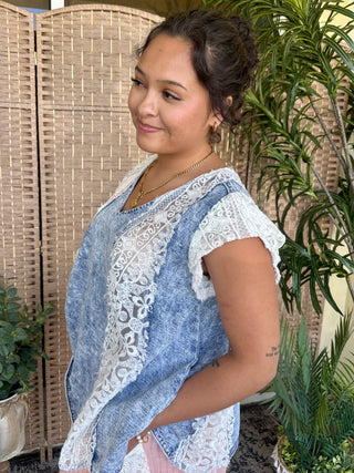 Blue chambray top with white lace patchwork panels and short sleeves.