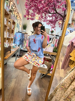 Periwinkle blue tee with red sequin lobster design and short sleeves.
