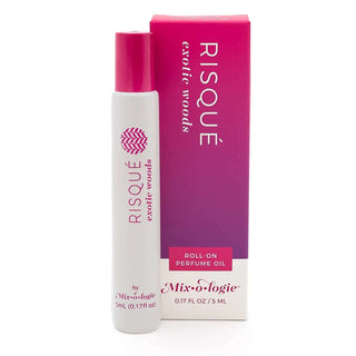 RISQUE Exotic Woods Mixologie Rollerball Perfume on a bed of natural wood pieces, showcasing its luxurious fragrance blend.