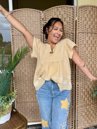 Yellow gingham short-sleeve top with lace trim and embroidered details on relaxed fit blouse.
