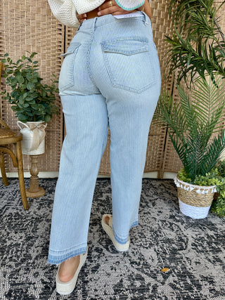 Light blue and white pinstripe straight-leg jeans with frayed hem detail, back view.
