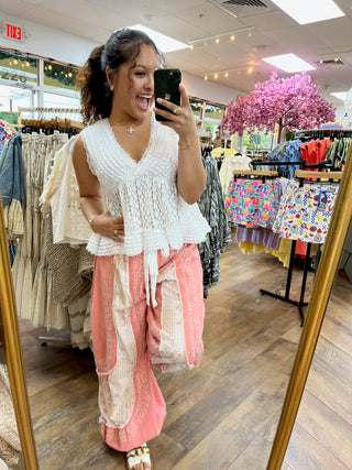 Coral jogger pants with cream embroidered patchwork detail and drawstring waist.
