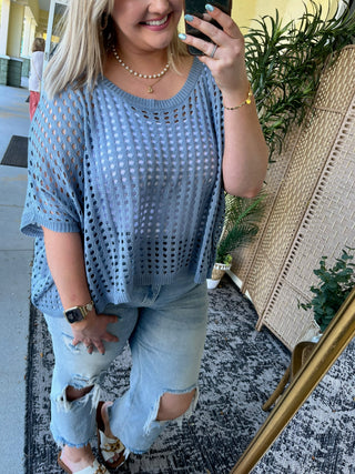 Blue open-knit dolman top with short sleeves and textured pattern detail.
