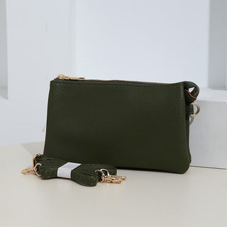 Olive green crossbody faux leather organizer purse with adjustable strap and zippered compartments. Stylish and functional accessory.