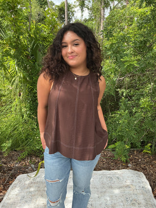 Light blue sleeveless tank top with contrast stitching, perfect for layering or casual wear
