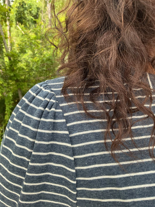 Light blue and white striped cardigan with a button front and a relaxed fit