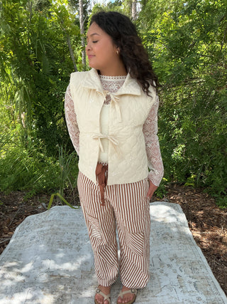 Ivory quilted vest with floral embroidery and a tie front detail