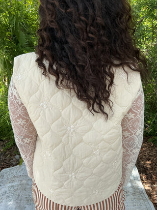 Ivory quilted vest with floral embroidery and a tie front detail