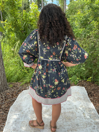 Dark navy floral dress with a contrast hem and band, featuring a feminine silhouette and elegant design