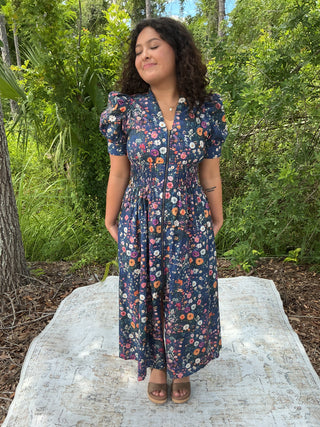 Navy floral print dress with puff sleeves, zip front, and smock waist detail