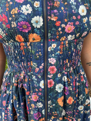 Navy floral print dress with puff sleeves, zip front, and smock waist detail