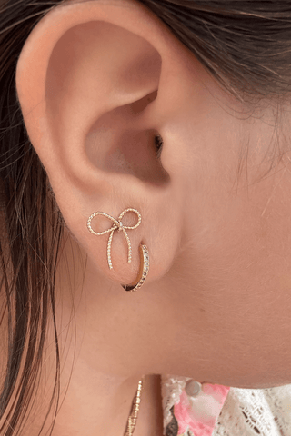 Alt text: "Gold & Rhinestone Huggie Hoop Earrings by Lauren Kenzie, featuring a Lifetime Warranty.