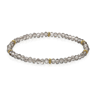 Gray faceted beaded bracelet with gold-tone spacer accents and elastic band.
