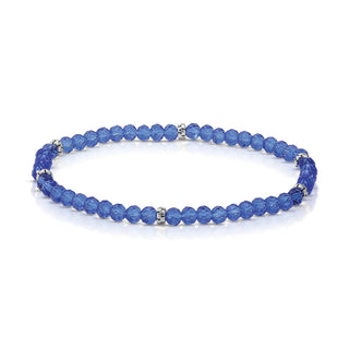 Blue faceted beaded bracelet with silver spacer accents and elastic band.
