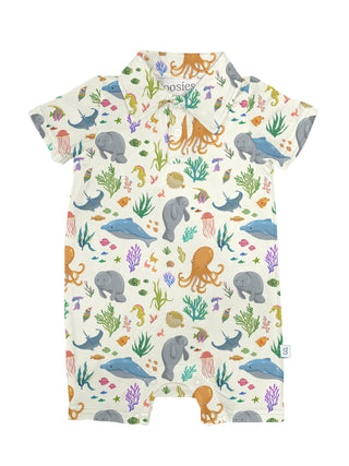 Cream short-sleeve romper with colorful ocean print featuring whales, octopuses, jellyfish, and seaweed.
